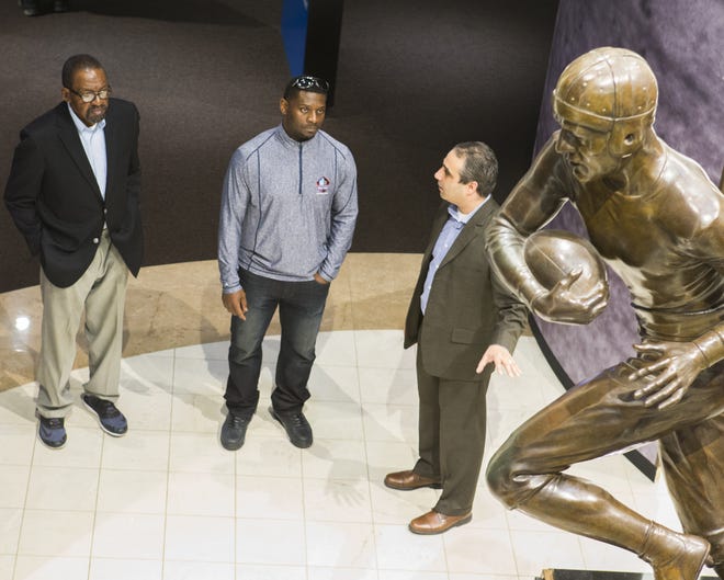Pro Football Hall of Fame Class of 2017 members Kenny Easley (left) and LaDainian Tomlinson (middle) tour the Hall with Saleem Choudhry, Director - Exhibits/Museum Services for the Pro Football Hall of Fame, on Monday, April 3, 2017. (CantonRep.com / Bob Rossiter)