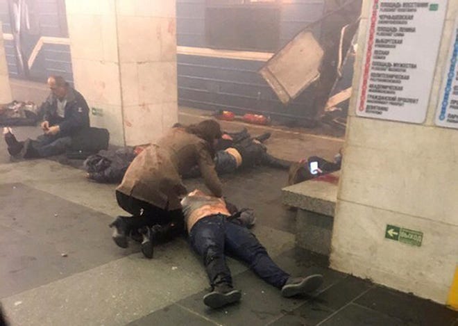 Blast victims lie near a subway train hit by a explosion at the Tekhnologichesky Institut subway station in St.Petersburg, Russia, Monday, April 3, 2017. The subway in the Russian city of St. Petersburg is reporting that several people have been injured in an explosion on a subway train. THE ASSOCIATED PRESS