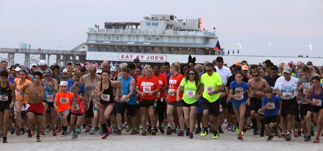 Runners competing in the 49th Annual Easter Beach last year leave the starting line. [NEWS-JOURNAL/JIM TILLER]