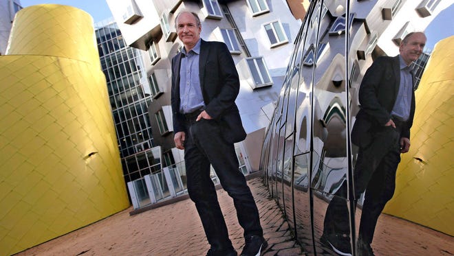 In this Monday, April 3, 2017, photo, Tim Berners-Lee poses outside his office at the Massachusetts Institute of Technology in Cambridge, Mass. (AP Photo/Charles Krupa)