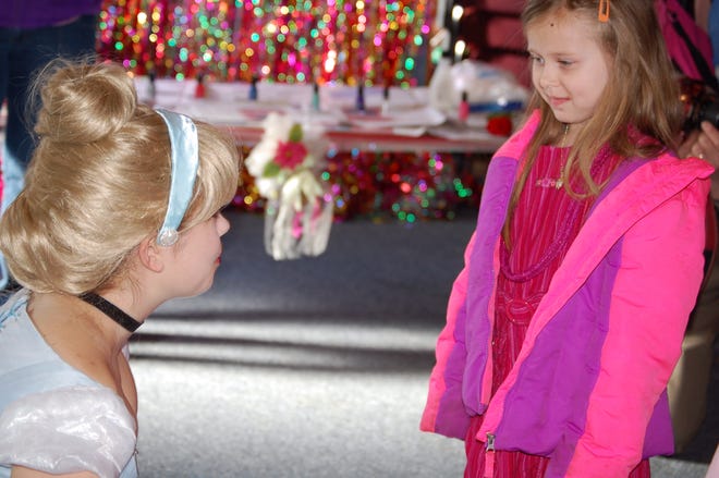 Elizabeth Richardson, 5, talks with Cinderella during Princess Day at the Hillsdale Salvation Army. [NANCY HASTINGS PHOTO]