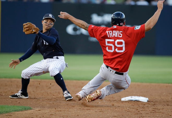 Ronald Torreyes of the Yankees moves to tag Boston's Sam Travis on a steal attempt on March 21.