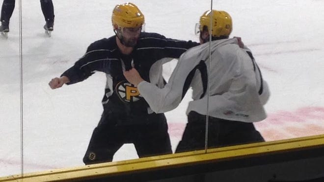 After practice on Tuesday, Tyler Randell, left, instructed Charlie McAvoy on how to fight.