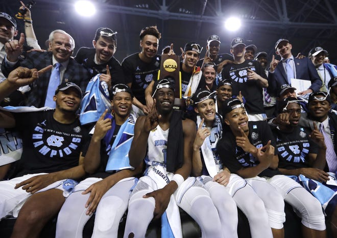 North Carolina players celebrate with the trophy after the championship game against Gonzaga at the Final Four NCAA college basketball tournament, Monday, April 3, 2017, in Glendale, Ariz. North Carolina 71-65. (AP Photo/David J. Phillip)