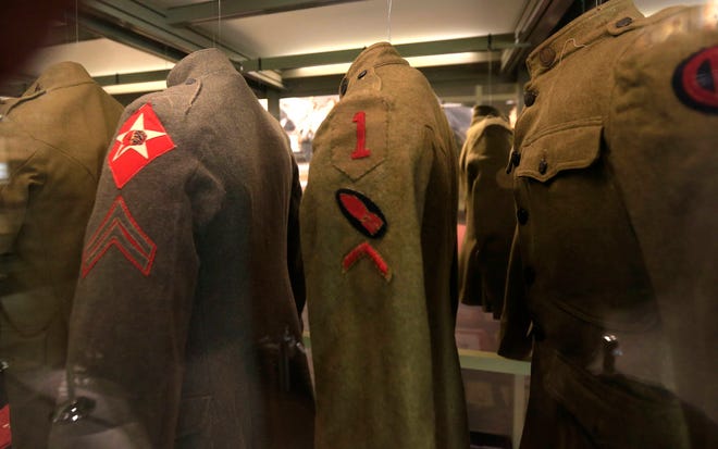 In this Feb. 16, 2017 photo uniforms hang on display at the National World War I Museum in Kansas City, Mo. (AP Photo/Orlin Wagner)