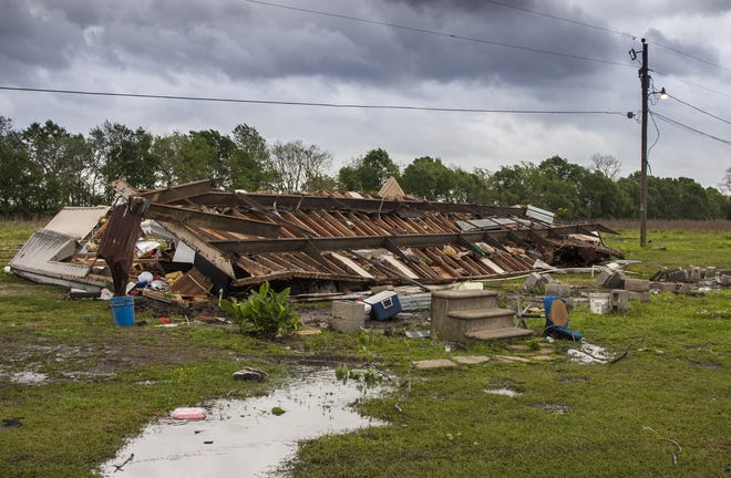 The remains of a trailer lie where a woman and her 3-year-old daughter were killed Sunday during a severe storm in Breaux Bridge, Louisiana. [LUCIUS FONTENOT/THE DAILY ADVERTISER VIA AP]