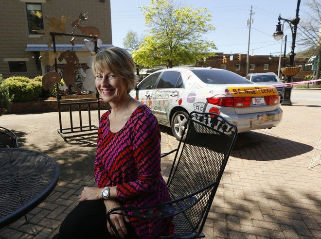 Amy Echols, executive director of the Kentuck Art Center, talks Tuesday about the block party outside Kentuck. The Saturday party will feature the auctioning off of the art car that is on display outside the Kentuck Center in downtown Northport. [Staff Photo/Gary Cosby Jr.]