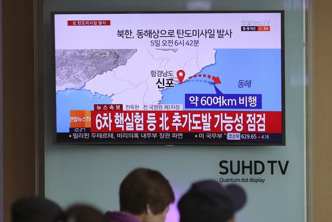 Visitors sit in front of the TV screen showing a news program reporting about North Korea's missile firing, at Seoul Train Station in Seoul, South Korea, Wednesday, April 5, 2017. North Korea fired a ballistic missile into its eastern waters Wednesday, U.S. and South Korean officials said, amid worries the North might conduct banned nuclear or rocket tests ahead of the first summit between President Donald Trump and his Chinese counterpart Xi Jinping this week. The letters read "North Korea fired a ballistic missile into its eastern waters." THE ASSOCIATED PRESS