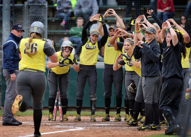 Oregon’s Janelle Lindvall (left) is welcomed home by her teammates after hitting a home run against UCLA in the fifth inning on Friday afternoon at Howe Field. (Chris Pietsch/The Register-Guard)