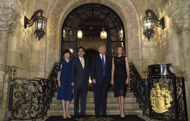 In a photograph transmitted around the world, President Donald Trump, second from right, and first lady Melania Trump, right, pose with Japanese Prime Minister Shinzo Abe, second from left, and his wife, Akie Abe, left, on the steps of Trump's Mar-a-Lago resort in Palm Beach. [ASSOCIATED PRESS ARCHIVE / 2017]