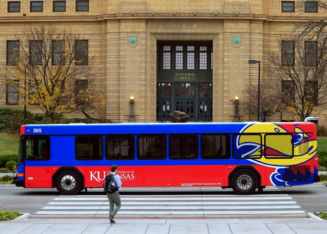 A bus passes in front of Strong Hall, an administrative building, Monday, Nov. 16, 2015 on the University of Kansas campus in Lawrence. A former University of Kansas theater student has filed a lawsuit alleging the school failed to investigate his sexual harassment claims against a professor. (AP Photo/Orlin Wagner)