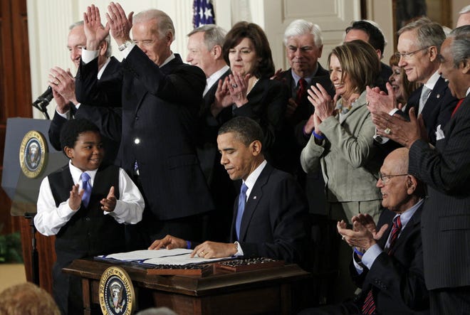 President Barack Obama signs the Affordable Care Act in March 2010.