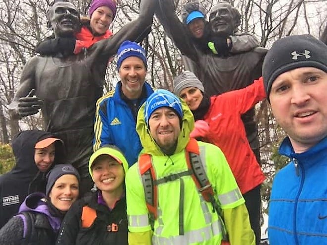 Waltham's Henry Ward poses with supporters in Newton during his ultra-marathon trek that included covering the Boston Marathon course four times on Saturday. [Courtesy Photo]
