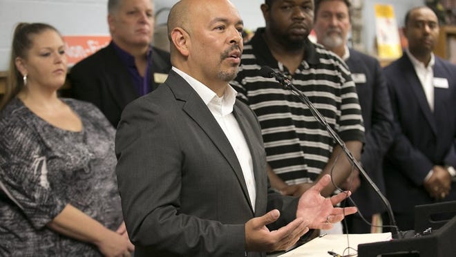 Several public officials, including school Trustee Paul Saldaña, speaking, gathered at Odom Elementary in South Austin last year to discuss reactions to the proposed city budget.