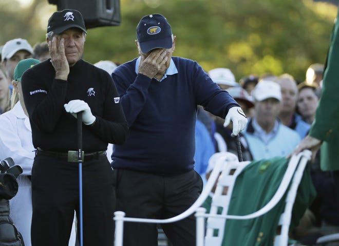 Jack Nicklaus and Gary Player wipe tears from their eyes as a chair is draped with a green jacket to honor Arnold Palmer before the start of the first round of the Masters on Thursday in Augusta, Ga. [AP Photo / David J. Phillip]
