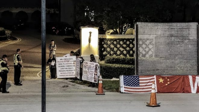 Protesters had gathered near the entrance to Eau Palm Beach on Wednesday night. They later moved across the street. Photo by Jim Zisson