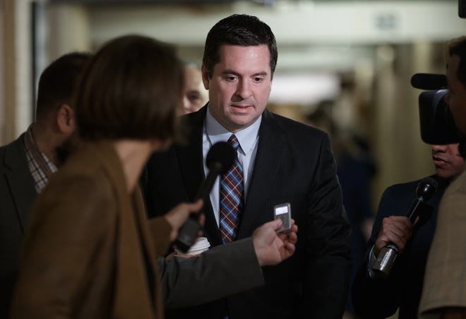 In this March 28, 2017 file photo, House Intelligence Committee Chairman Rep. Devin Nunes, R-Calif. is pursued by reporters on Capitol Hill in Washington. Nunes says heþÄôs temporarily stepping aside from Russia probe amid ethics accusations. THE ASSOCIATED PRESS