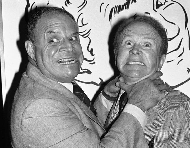 FILE - In this Nov. 10, 1977 file photo, comedian Don Rickles, left, pretends to strangle fellow comedian Red Buttons prior to an Annual Stag Roast in Los Angeles. Rickles died Thursday, April 6, 2017, of kidney failure at his Los Angeles home. He was 90. THE ASSOCIATED PRESS