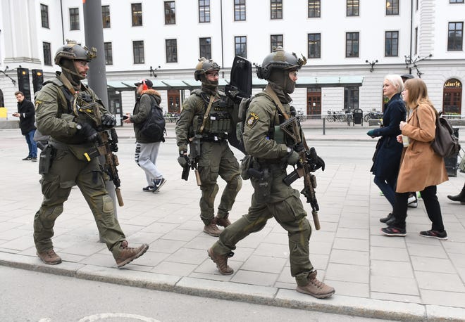 Armed police patrol outside the central station in Stockholm after a truck crashed into a department store injuring several people in a different part of Stockholm, Sweden, Friday. Swedish Prime Minister Stefan Lofven says everything indicates a truck that has crashed into a major department store in downtown Stockholm is "a terror attack." [JESSICA GOW / TT NEWS AGENCY via AP]