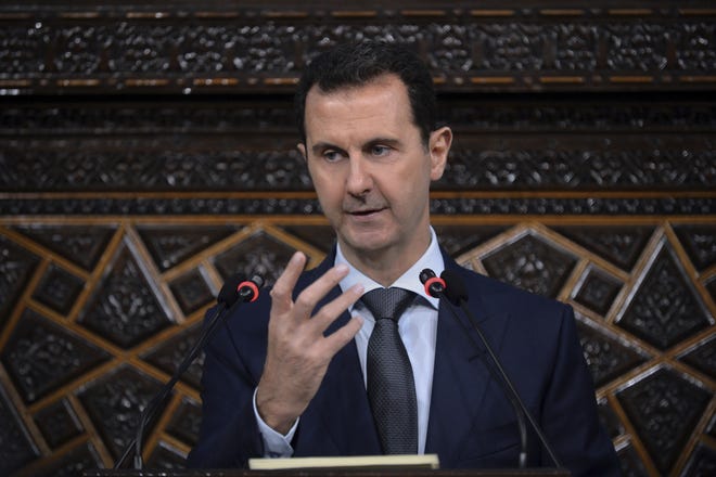In this June 7, 2016 file photo released by the Syrian official news agency SANA, Syrian President Bashar Assad, addresses a speech to the newly-elected parliament at the parliament building, in Damascus, Syria. Assad's government came under mounting international pressure Thursday after a chemical attack in northern Syria, with even key ally Russia saying its support is not unconditional. [SANA via AP]