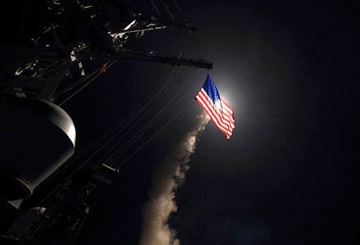 In this image provided by the U.S. Navy, the guided-missile destroyer USS Porter (DDG 78) launches a tomahawk land attack missile in the Mediterranean Sea, Friday, April 7, 2017. The United States blasted a Syrian air base with a barrage of cruise missiles in fiery retaliation for this week’s gruesome chemical weapons attack against civilians. (Mass Communication Specialist 3rd Class Ford Williams/U.S. Navy via AP)