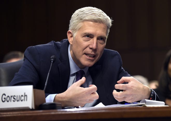 In this March 21, 2017, file photo, Supreme Court Justice nominee Judge Neil Gorsuch explains mutton busting, an event held at rodeos similar to bull riding or bronc riding, in which children ride or race sheep, as he testifies on Capitol Hill in Washington during his confirmation hearing before the Senate Judiciary Committee.