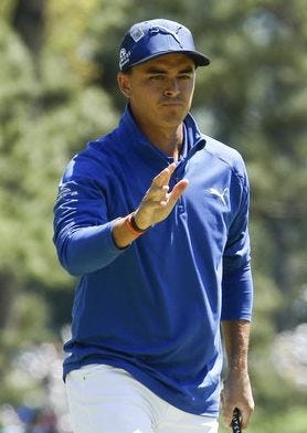 Rickie Fowler waves after putting on the first hole during the second round of the Masters Friday in Augusta, Ga. [AP Photo/Charlie Riedel]