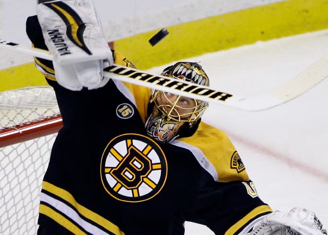 Bruins goalie Tuukka Rask makes a stick save during the first period of Thursday's game against the Senators in Boston.