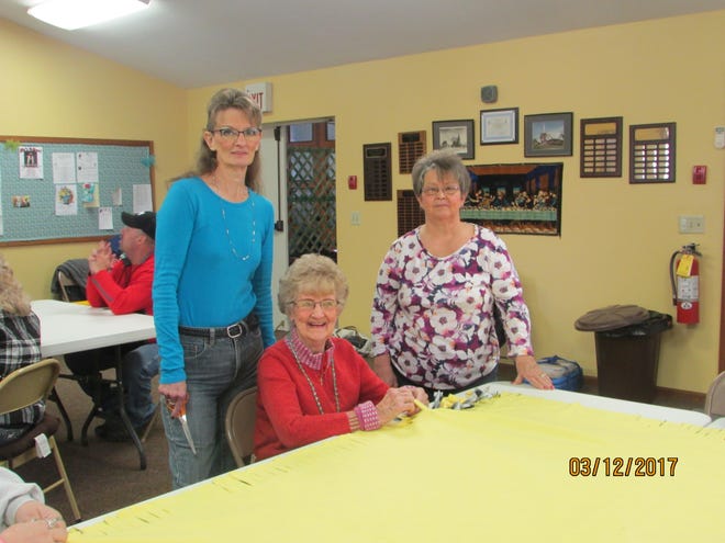 SUBMITTED PHOTO Pictured are Nancy Sukosd, Edith Taylor and Joy Miles working on blankets for the Woody Paul Blanket Mission. The 10th annual retreat will be held at the Deersville United Methodist Church April 29.