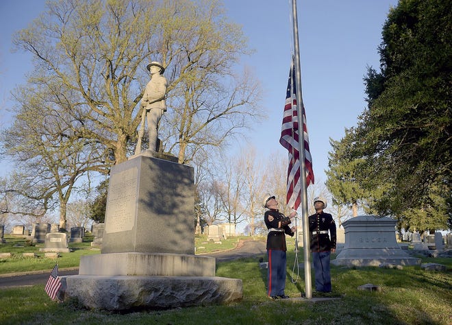 United State Marine Corp Staff Sgt. Kevin Harmon, left, and Pfc. David Aguirre raise the flag at Mount Mora Cemetery Thursday, April 6, 2017, in St. Joseph, Mo. They also laid a wreath at the World War I memorial in honor of the 100th anniversary of the United States entering the first world war. [Jessica A. Stewart / AP]