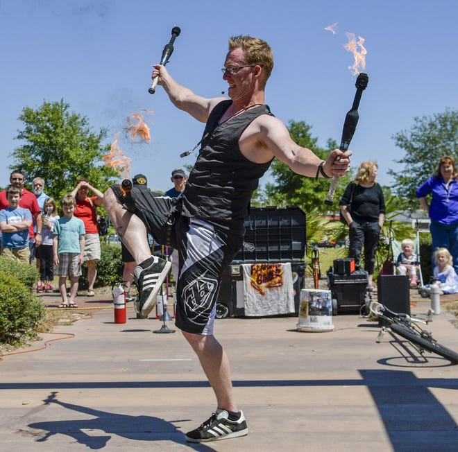 The Flaming Ginger performs at the Busker Festival in Eustis on Saturday. [PAUL RYAN / CORRESPONDENT]