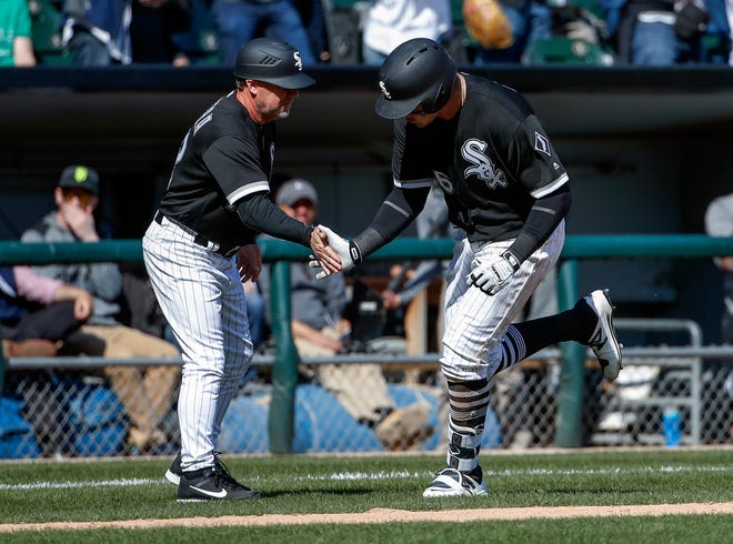 Chicago White Sox designated hitter Avisail Garcia, right, is congratulated by third base coach Nick Capra, left, after hitting a two-run home run off Minnesota Twins relief pitcher Justin Haley during the sixth inning of a baseball game, Saturday, April 8, 2017, in Chicago. (AP Photo/Kamil Krzaczynski)