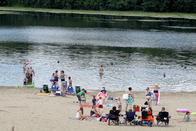 Beachgoers enjoy a warm afternoon at Olson Lake Beach at Rock Cut State Park in Loves Park. [RRSTAR.COM FILE PHOTO]