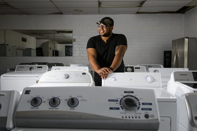 Roberto Henry at his Raeford Road business, Lifetime Appliance, where he refurbishes used washers and dryers. He lets homeless people bring their clothes to his shop to wash. [Staff photo by Shane Dunlap]