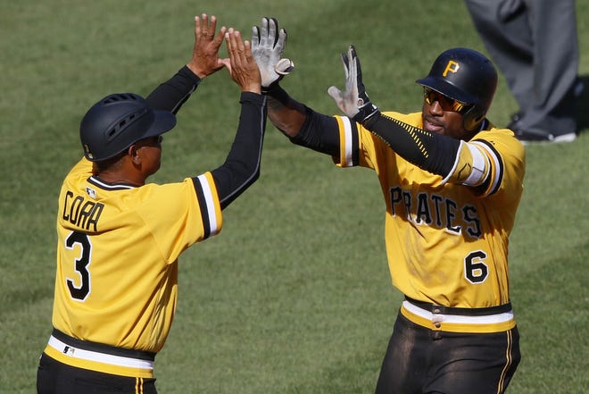 Pirates' Starling Marte rounds third to greetings from third base coach Joey Cora after hitting a two-run, walk-off home run off Atlanta Braves relief pitcher Jose Ramirez in the tenth inning Sunday in Pittsburgh.7. The Pirates won 6-5.