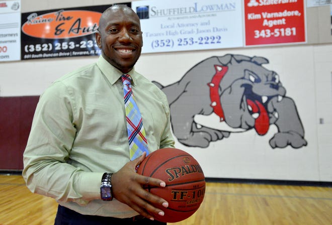New girls basketball coach Marcus Hawkins poses for a portrait in the Tavares High School gym on Wednesday. Hawkins believes the Bulldogs can be one of the best teams in the state. [AMBER RICCINTO / DAILY COMMERCIAL]