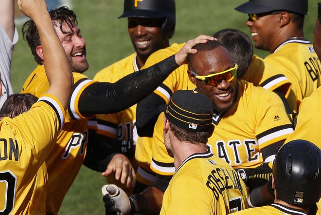 Pirates' Starling Marte, right, celebrates with teammates after hitting a walk-off two-run home run off Atlanta Braves relief pitcher Jose Ramirez in the tenth inning on Sunday in Pittsburgh. The Pirates won 6-5.