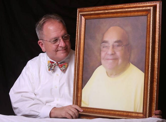 Chris MacLellan poses with a portrait of his late partner, Richard Schiffer, who died in 2014 of cancer. The couple participated in a Putlitzer prize-nominated documentary about their experience as an LGBT caregiver and patient respectively. MacLellan will be the keynote speaker at an ElderSource Institute caregiving event Thursday in Jacksonville. (Provided by Chris MacLellan)