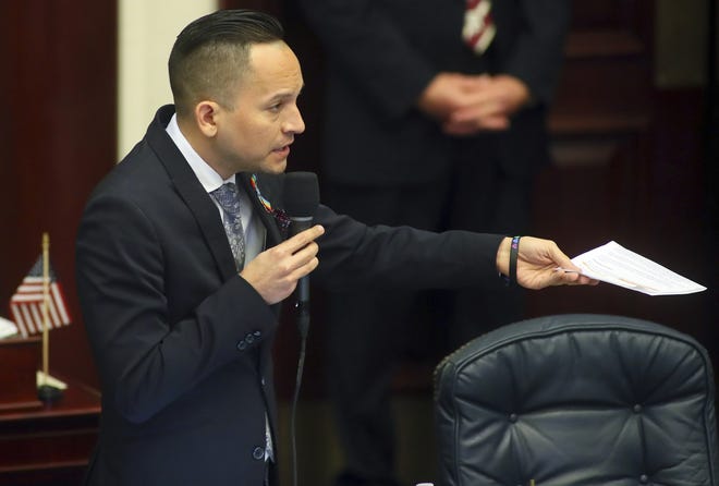 State Rep. Carlos Guillermo Smith, D-Orlando, asks a question of Rep. Bobby Payne, R-Palatka, about his "stand your ground" bill on April 4 on the floor of the Florida House at the Capitol in Tallahassee. Lawmakers appear likely to reach agreement on a bill that would shift a key burden of proof in "stand your ground" self-defense cases. [Phil Sears/The Associated Press]