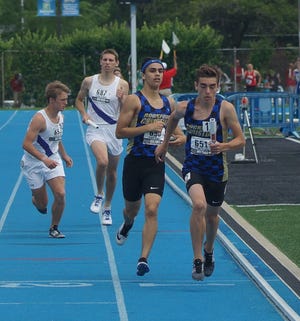 Rockford Christian's Josiah Vogel handed off the baton to Riley Wells, who finished his state title run in last year's Class 1A finals of the 3,200-meter relay in Charleston. [RRSTAR.COM FILE PHOTO]