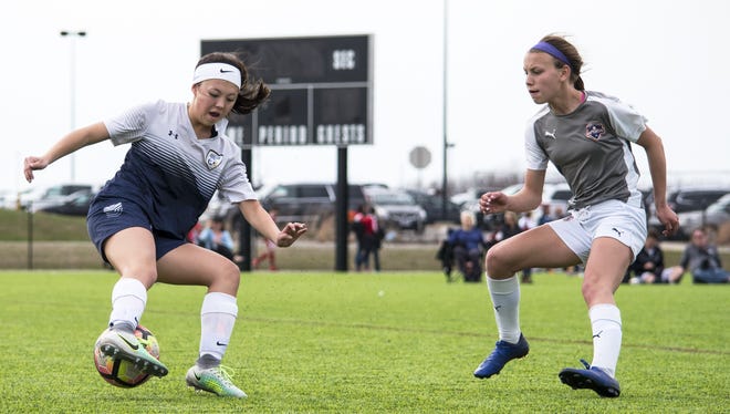 Erica Moline (left), a midfielder for the Prior Lake (Minnesota) Typhoon, attempts to keep the ball from Rockford Raptors Taylor Harrison on Sunday, April 9, 2017, during the Puma Champions Cup tournament at Mercyhealth Sportscore Two in Loves Park. [KAYLI PLOTNER/RRSTAR.COM STAFF]