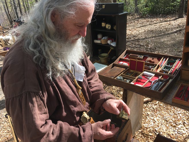Rick Stuck, of the Backcountry Militia, demonstrates surgeon's tools of the 1800s at the group's first encampment of the season on Sunday. [Joyce Orlando/The Star]