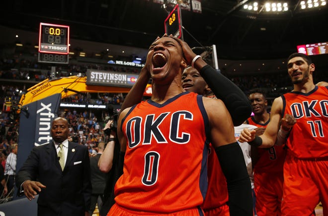 Oklahoma City Thunder guard Russell Westbrook celebrates after hitting a buzzer beater three point shot to win the game against the Denver Nuggets following a basketball game Sunday in Denver. Oklahoma City beat Denver 106-105. Westbrook also broke the NBA record for triple doubles with 42. [THE ASSOCIATED PRESS / JACK DEMPSEY]