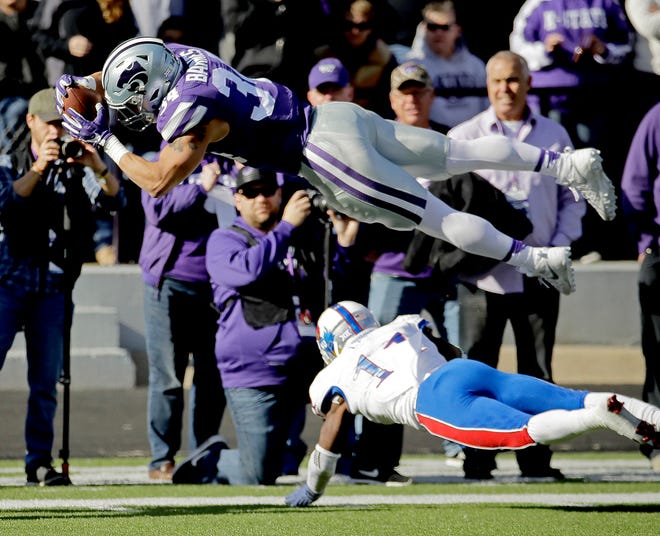 Kansas State running back Alex Barnes, top, dives into the end zone over Kansas linebacker Mike Lee to score a touchdown during the 2016 Sunflower Showdown in Manhattan. (AP Photo/Charlie Riedel)
