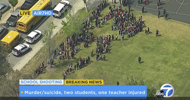 In this frame from video provided by KABC-TV, faculty and students evacuate North Park School Elementary School as emergency personnel respond to a shooting inside on Monday, April 10, 2017, in San Bernardino, Calif. KABC-TV VIA THE ASSSOCIATED PRESS