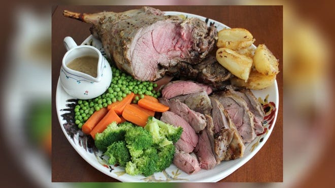 Roast leg of lamb served with roast potatoes, buttered carrots, English peas and broccoli. Photo by Paul William Coombs