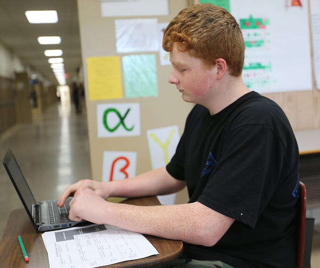 TIMES-REPORTER JIM CUMMINGS

Conotton Valley student Andrew Bogner works on homework in a clasroom at the school.