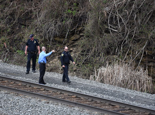 Police officers investigate an area in Norfolk Southern's Conway Yards Tuesday after a man with a gunshot wound was found there after a shooting at 1321 4th Street in Conway.