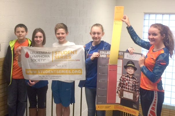 Jonesville Middle School student council members Caiden Fenton, Mariah Gardella, TJ Berlin, Kayleigh Adams and Alyssa Lucas hold up posters used during the fundraiser. Student Council Co-Advisers (Not pictured): Kris Stanton and Kourtney Merz.