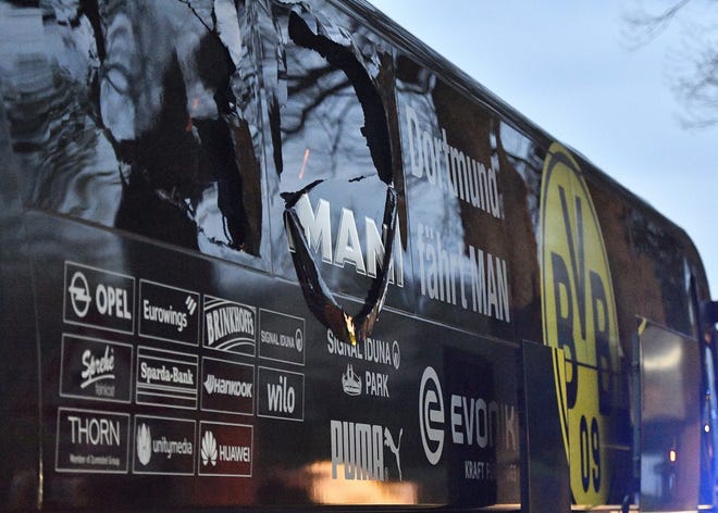 A window of Dortmund's team bus is damaged after an explosion before the Champions League quarterfinal soccer match between Borussia Dortmund and AS Monaco in Dortmund, western Germany, Tuesday, April 11, 2017. THE ASSOCIATED PRESS